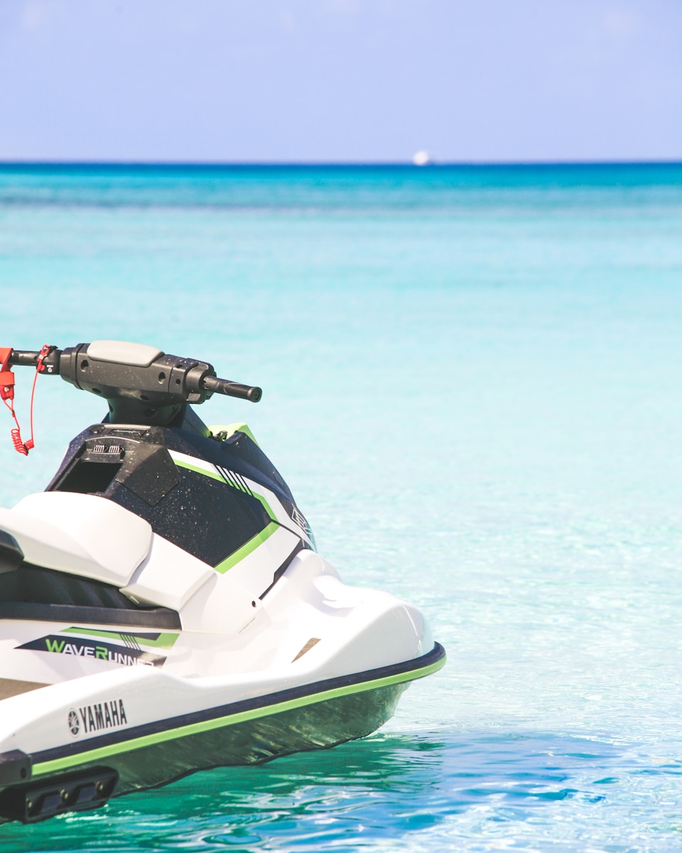 white and green personal watercraft on water toy vehicle